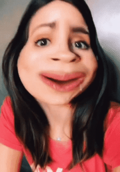 Woman In Red Shirt With M Making Funny Face GIF
