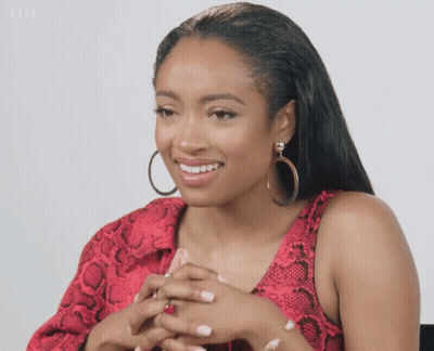 Woman In Red Snakeskin Top And Hoop Earrings GIF