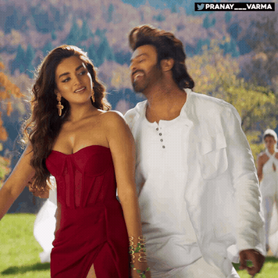 Woman In Red Strapless Dress Next To Man In White Shirt GIF