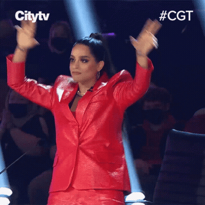 Woman In Red Suit Applauding In Front Of Citytv Logo GIF