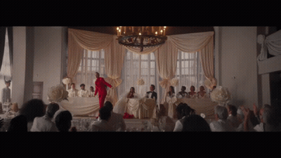 Woman In Red Suit At Wedding Reception GIF