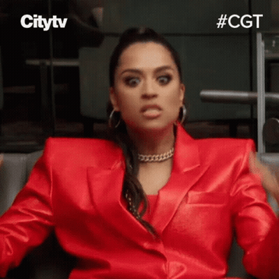 Woman In Red Suit Making Face GIF