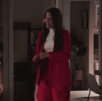 Woman In Red Suit Next To Woman In White Shirt GIF