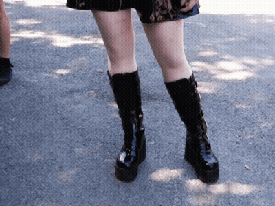 Woman In Red Sweater And Black Skirt With Potted Plant GIF