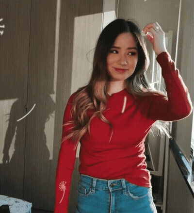 Woman In Red Sweater And Blue Jeans By Window GIF