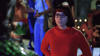 Woman In Red Sweater And Glasses Standing Before Group GIF