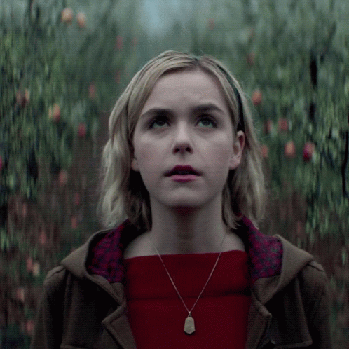 Woman In Red Sweater And Necklace Looking Up GIF