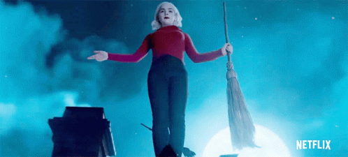 Woman In Red Sweater Flying With Broom GIF
