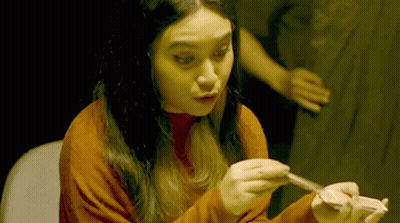 Woman in Red Sweater Holding Card
