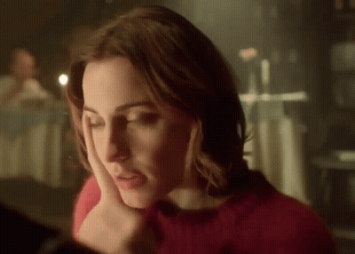 Woman In Red Sweater Looking Down GIF