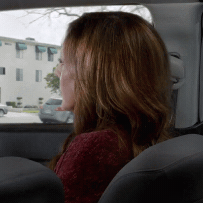 Woman In Red Sweater Looking Out Car Window GIF
