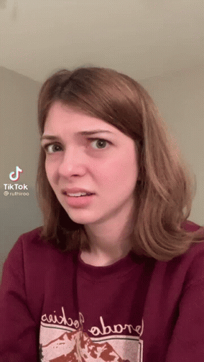 Woman In Red Sweater Saying Above Making Funny Face GIF