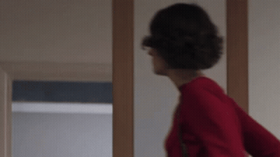 Woman In Red Sweater Standing GIF