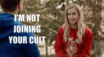 Woman In Red Sweater Talking To Man In Blue GIF