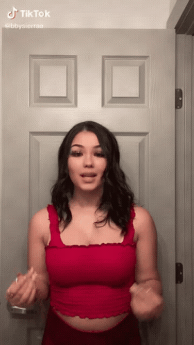 Woman In Red Tank Top Making Funny Face GIF