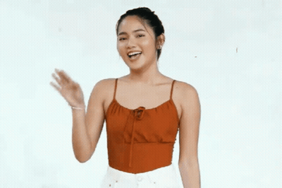 Woman In Red Tank Top Smiling And Waving GIF