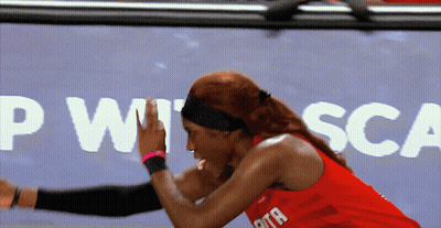 Woman In Red Tank Top Stretching In Front Of PWT SCA Sign GIF