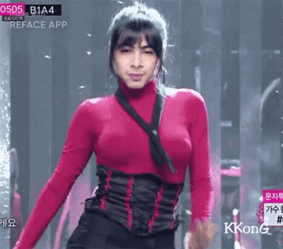 Woman In Red Top And Black Corset On Stage GIF