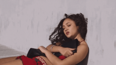 Woman In Red Top And Black Shorts Saying Sport GIF