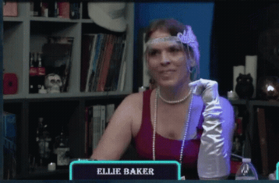 Woman In Red Top And White Gloves Sitting At Table Saying Ellie Baker GIF