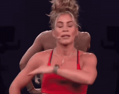 Woman In Red Top Dancing In Front Of Man GIF