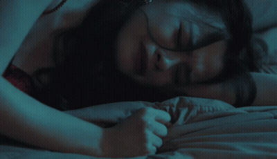 Woman In Red Top Laying On Bed GIF