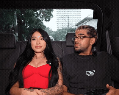 Woman In Red Top Next To Man In Balenciaga Shirt GIF