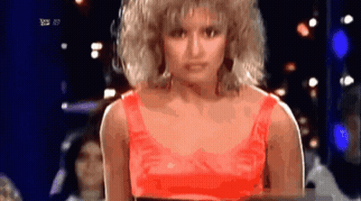 Woman In Red Top Standing In Front Of RTL HD TV Screen GIF
