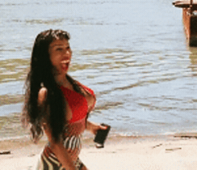 Woman In Red Top Walking On Beach GIF