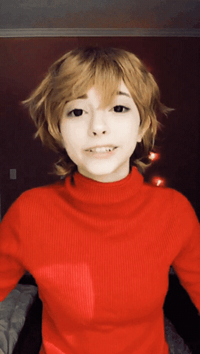 Woman In Red Turtleneck And Blonde Wig GIF