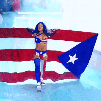 Woman In Red White And Blue Holding Puerto Rico Flag GIF