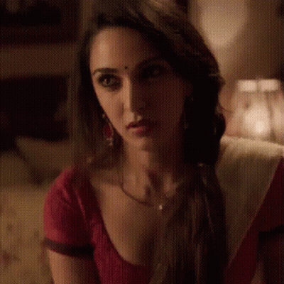 Woman In Red White Dress Looking At Camera GIF