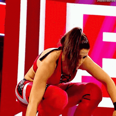Woman In Red Wrestling Outfit Squatting GIF