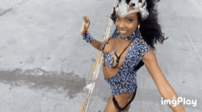 Woman In Revealing Outfit Dancing In Parade GIF
