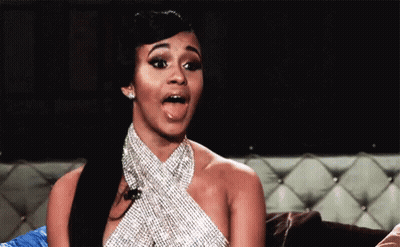 Woman In Rhinestone Dress Sticking Tongue Out On Couch GIF