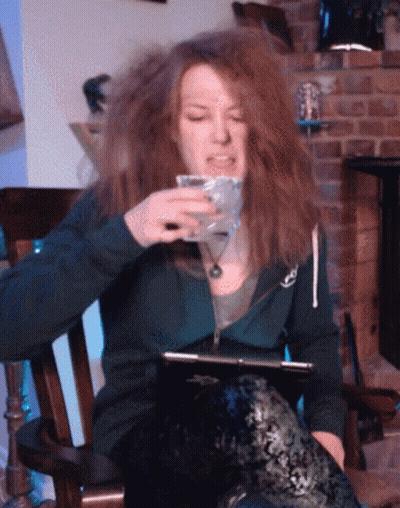 Woman In Rocking Chair Holding Glass GIF