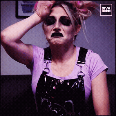 Woman In Rolling Stones Shirt In Front Of Yellow Wall GIF