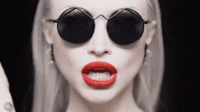 Woman In Round Sunglasses Making Funny Face GIF