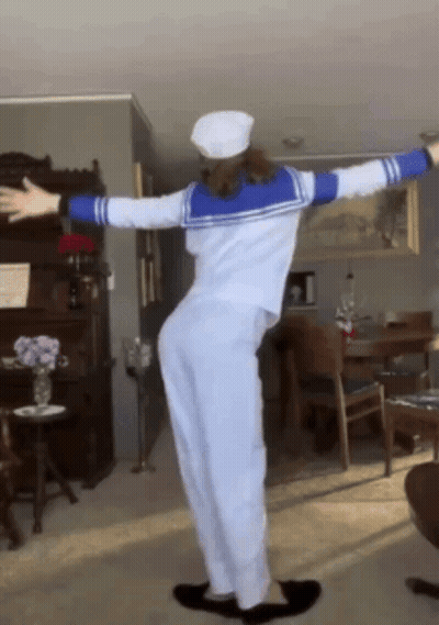 Woman In Sailor Costume With Arms Outstretched GIF
