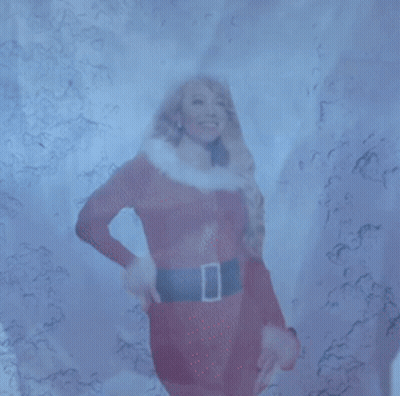 Woman In Santa Claus Outfit Standing In Snow GIF