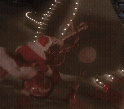 Woman In Santa Costume Riding Bike At Night GIF
