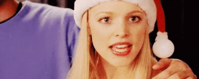 Woman In Santa Hat Holding Christmas Present GIF