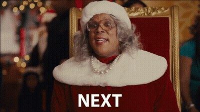 Woman In Santa Hat With Word Next GIF