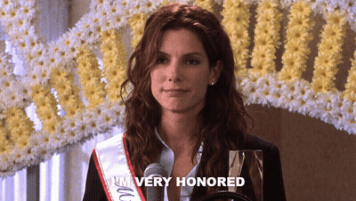 Woman In Sash Saying I'm Very Honored At Microphone GIF