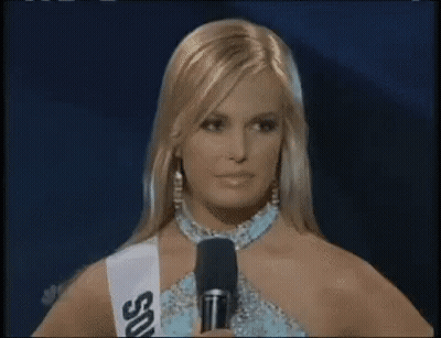Woman In Sash Saying SSU At Microphone GIF