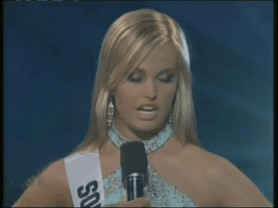 Woman In Sash Saying US Talking Into Microphone GIF