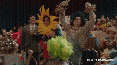 Woman In Scarecrow Costume Holding Scarecrow GIF