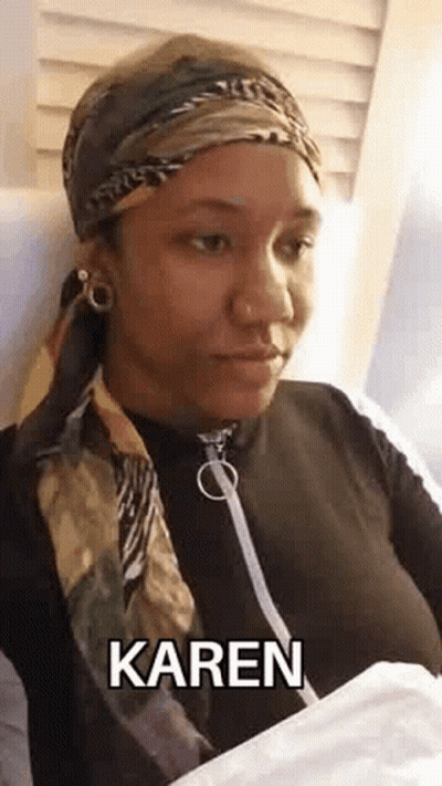 Woman In Scarf, Headband, And Bandana Sitting In Chair GIF
