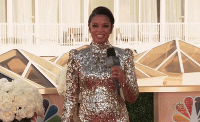 Woman In Sequined Dress By Golden Globe Sign GIF