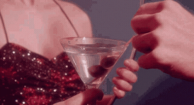 Woman In Sequined Dress Holding Martini GIF